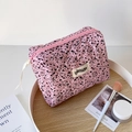 Detailed view of pink quilted makeup bag with ink splash texture and side woven label - Rose Red Splash Ink