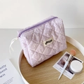 Detailed view of purple quilted makeup bag with white ink splash and ribbon zipper pull - Purple Floral Style