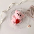Pink plush bear keychain with red LOVE heart displayed on a decorative glass plate - Pink