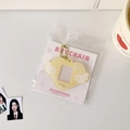 Detail view of yellow glitter acrylic heart-shaped photo card holder with bead chain - Yellow