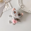 Close-up of grey plush cat keychain with pink heart bag and metallic ring attachment - Gray