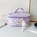 Quilted light purple cosmetic bag with white floral patterns and soft ribbon handle - Purple