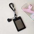 Detail of black leather card holder with neck lanyard and embossed heart pendant charm - Black