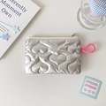 Close-up of silver quilted heart pouch with pink lanyard and smooth metal zipper - Heart-Silver Gray