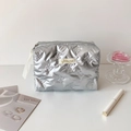 Detail of silver puffy makeup bag featuring quilted butterfly patterns and metallic finish - Silver