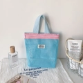 Detail of blue mesh organizer bag with pink zipper for toiletries and skincare - Blue