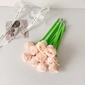 Close-up of pink and white gradient rose pens in a glass cup with elegant ribbons - Champagne