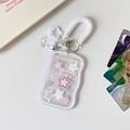 Detail of light purple star photo card holder with white spiral lanyard and star charms - White