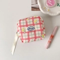 Detailed close-up of pink checkered pouch with yellow cherry embroidery and zipper - Pink
