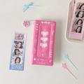 Detailed view of pink photocard binder with ribbon design and floral charm pendant - Rose Red