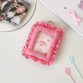 Detailed view of pink fabric card holder with ruffled edges and metallic hanging ring - Rose Red