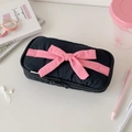 Detail of black quilted pencil case with pink satin ribbon bow and dual zippers - Black