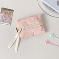 Detailed macro of pink bow-embossed mini pouch with long ribbon zipper pull and brand tag - Pink
