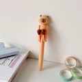 Close-up of creative pink capybara boxing pen with decorative school stationery items - Beige Capybara