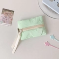 Detail of light green quilted pouch featuring bow textures and socute ribbon zipper - Green
