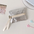 Detail of silver puffy bow-embossed makeup bag with long ribbon zipper pulls - Silver