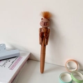 Close-up of creative cartoon capybara pen with boxing gloves and orange faux fur detail - Brown Hair Capybara