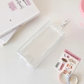 Close-up of a clear PVC organizer bag with a white metal hook for hanging storage - Transparent Rectangular - With Pendant