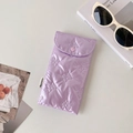 Close-up of a purple quilted sunglasses pouch with butterfly embroidery and heart buckle - Purple
