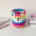 Detail of colorful rainbow plush pencil holder featuring an embroidered Shiba Inu face - Rainbow Dog