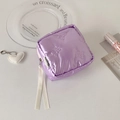 Detail of quilted purple pouch featuring embossed bow patterns and soft silk ribbon zipper - Blue Lotus