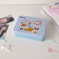 Detail view of a blue checkered tin storage box featuring cute retro puppy illustrations - Blue Plaid