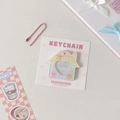 Detail of acrylic house-shaped card holder keychain with pink ball chain and heart window - Yellow Cake