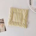 Detail of yellow and white striped quilted placemat with elegant embroidery label - Yellow Plaid