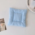 Detail of light blue striped cotton placemat featuring a woven Hisocute brand label - Blue Stripe