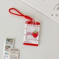 Detail of red strawberry photocard holder with sliding cover and matching woven lanyard - Red