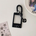 Close-up of black MP3 player style acrylic card holder with spring rope and heart charm - Black Style with Coiled Cord