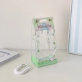 Detail of transparent PVC doll display bag featuring cute prints and a metal spring hook - Green Clover