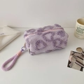 Detail of purple plush stationery bag featuring dark purple heart patterns and wrist strap - Purple