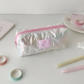 Close-up of holographic white star-quilted pencil case with pink zipper and bow detail - White