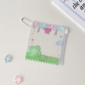 Close-up of clear PVC candy bag card holder with colorful wavy edges and star decorations - Green