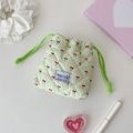 Close-up of mini green checkered drawstring pouch with cherry prints and quilted texture - Green