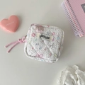 Macro detail of white quilted fabric organizer with pastel cartoon patterns and brand tag - White Star