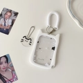 Close-up of cat-shaped silicone photocard holder with spring lanyard and acrylic charm - White Transparent Cat