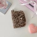 Detailed close-up of plush leopard print coin purse with white snap button and hanging ring - Brown