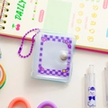 Macro detail of mini PVC photo album with purple checkerboard insert and metal bead chain - Purple-Purple Grid