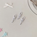 Three white swivel lobster clasps for DIY photo holder keychains on a decorative desk - One Hook