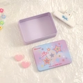 Detail of a purple star pattern tin storage box on a stylish white textured background - Gradient Star Style / Purple