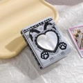 Detail of PVC photo album with heart-shaped cutout window and cute cat paw pattern - Black and White