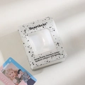 Macro shot of a white ink-splatter photocard binder with square window and Heartbeat text - Black and White Splatter