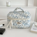 Floral quilted cosmetic bag with blue flower pattern and elegant ribbon handle design - Blue Floral - Large