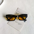 Cat-eye sunglasses with black frame and orange transparent lenses featuring silver studs - Black Frame Yellow Lens
