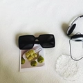 Classic black square oversized sunglasses with polished frames in a lifestyle setting - Black and Gray