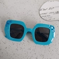 Teal oversized kids sunglasses with dark lenses and blue rhinestone accents on the frame - Blue