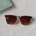 Rectangle beige sunglasses with brown gradient lenses lying on textured background - Grey Frame Tea Lens