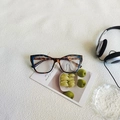 Retro cat-eye sunglasses featuring dark tortoise texture and transparent blue frame detail - Cream Marbled Clear Lens